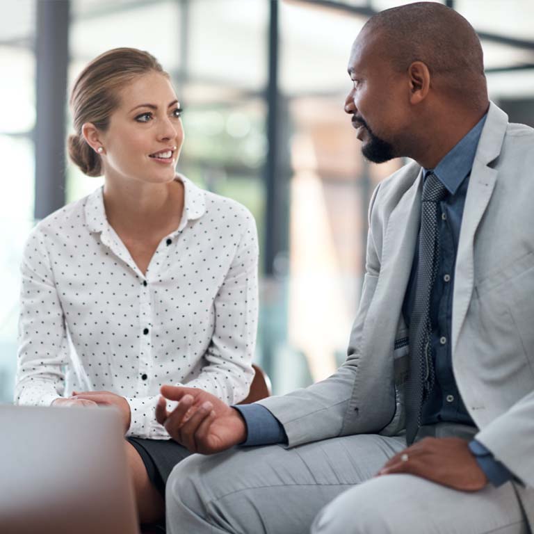 Shot of two businesspeople working together on a laptop in an office